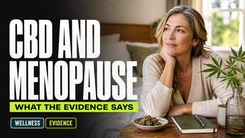 A midlife woman sits thoughtfully beside a bedroom window with a small dish of hemp flower on a nearby table.