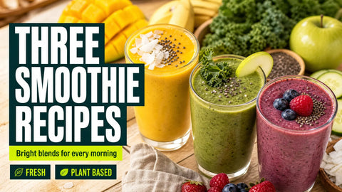 Three colorful smoothies in clear glasses sit among tropical fruit, leafy greens, berries, and seeds on a bright kitchen table.