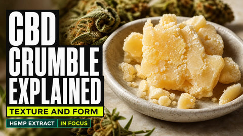 Macro photograph of pale amber CBD crumble fragments in a ceramic dish beside softly blurred hemp flowers.
